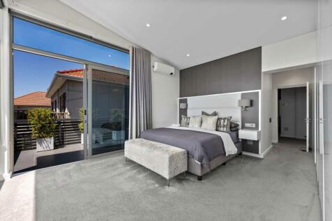 Spacious main bedroom with balcony