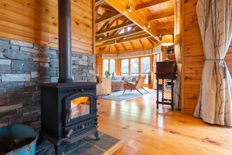 Dining room toward lounge in main residence with hearth 