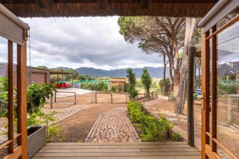 View from one of two Airbnb Stable Cottages toward games room and tennis court