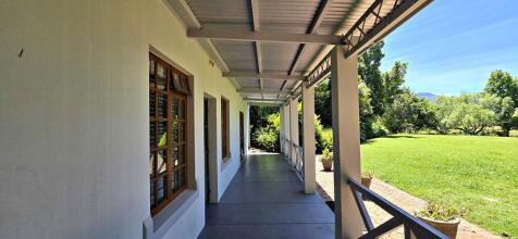 Lounge with door open onto undercover patio