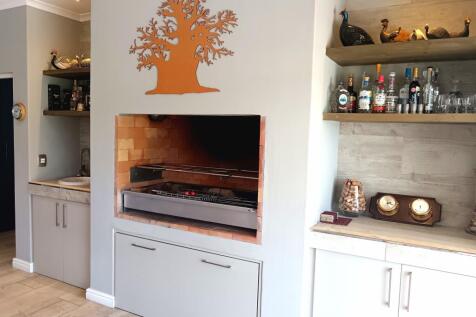 Indoor braai area with stainless steel grid and pan