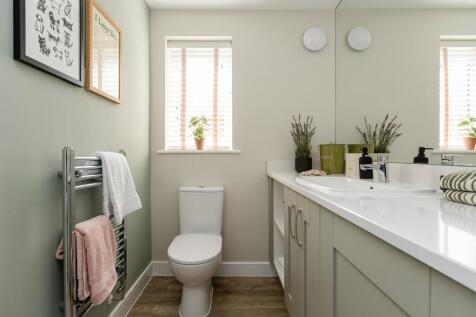 The downstairs cloakroom has space for the washing machine and ample storage