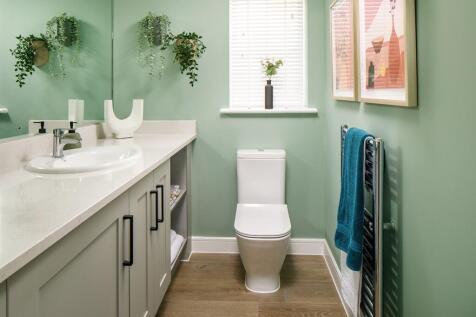 The downstairs cloakroom has space for the washing machine and ample storage