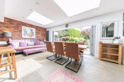 Dining and living space with bi-fold ...