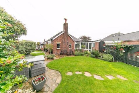 Neatly landscaped gardens surround