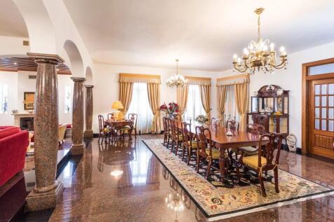 Elegant dining room with a long wooden table, chan