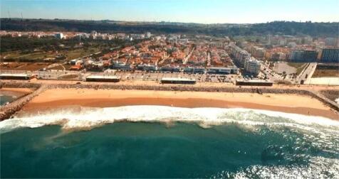Aerial view of a coastal town with a sandy beach a