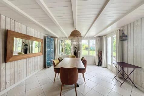 Bright dining room with a wooden table, six chairs