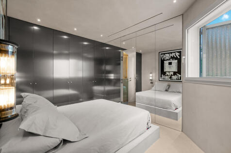 Master bedroom with mirror door to bathroom with shower