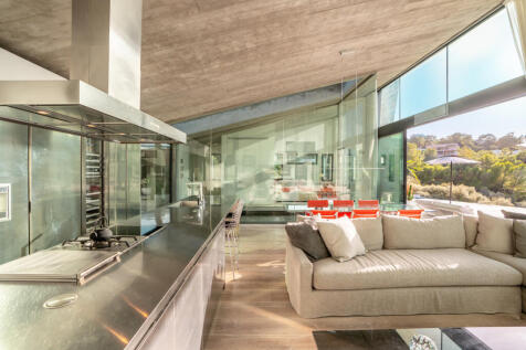 Kitchen-dining-living room with views to the outside and to the master area and pool