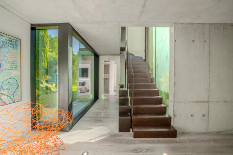 Staircase to the upper floor and access to the bedroom