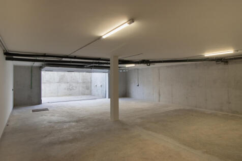 Spacious underground car park with 4 parking spaces and electric charging station