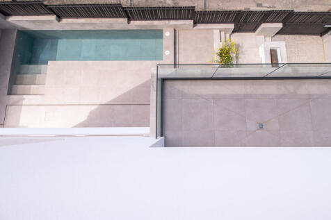View of the outdoor area with pool and balcony from the flat roof