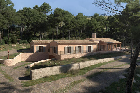 Lateral view of the villa with woodland in the background