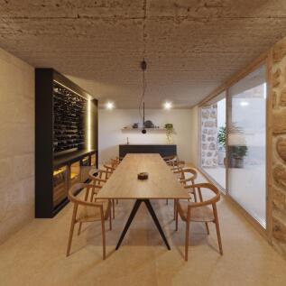 Dining area with wine cellar and access to the courtyard through fully glazed sliding doors