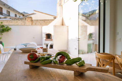 Mediterranean-inspired open kitchen with glass front facing the patio