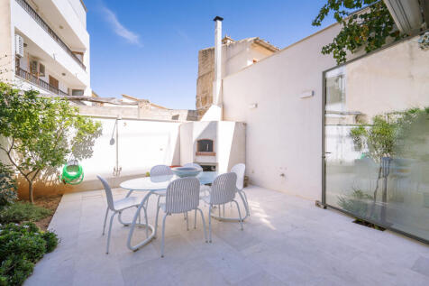 Patio with a small garden, lemon tree, and pizza oven built by a professional chef