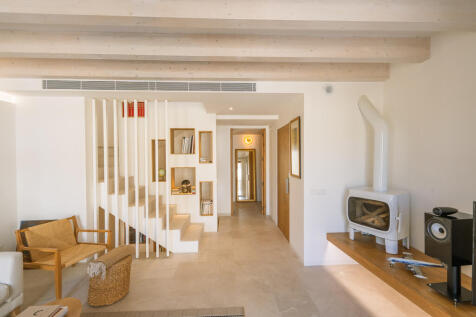 View from the living room past the staircase towards the bedroom on the first floor