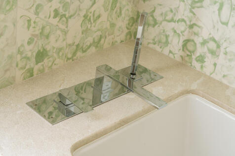 Stone and handcrafted tiles reflect the home&#39;s high quality standards