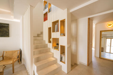 Staircase to the second floor with space for collectibles, books, and personal treasures