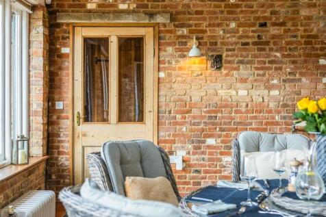 Sunroom with rustic brick charm