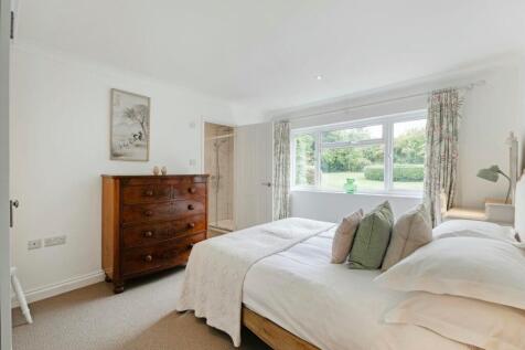 Bedroom four with en-suite and garden views
