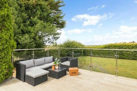 Relaxed terrace seating with the sea in the distan