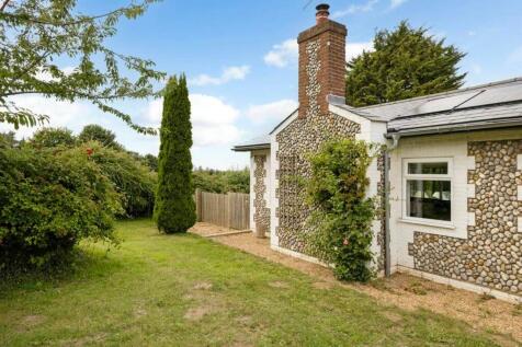 Character flintwork and tall brick chimney