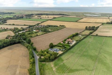 Panoramic coastal views over rolling farmland