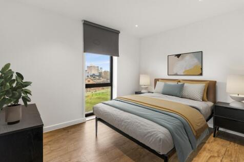 Experience tranquility in this stylish bedroom with a cityscape view.