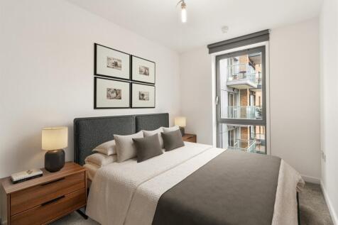 Relax in style in this contemporary bedroom oasis, featuring sleek design and ample natural light.