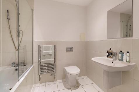 Step into this stylish bathroom with modern amenities and clean lines.