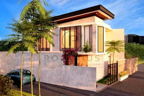 Modern two-story house with large windows, surroun