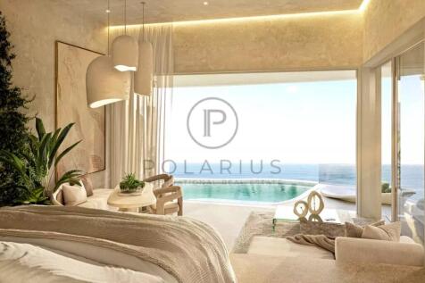 A luxurious, light-filled bedroom features a moder