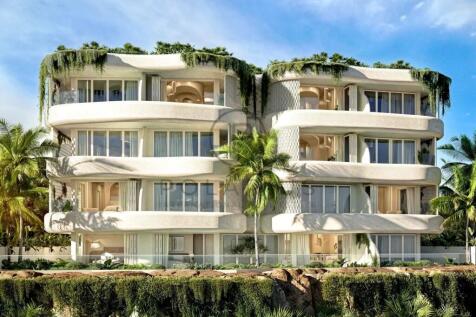 Modern building with curved balconies, abundant gr