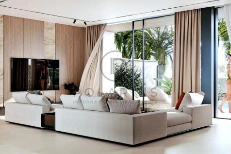 A modern, bright living room with a white sectiona