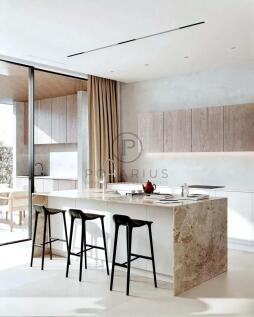 A modern kitchen featuring a marble island with th