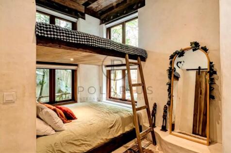 Cozy bedroom with a bunk bed setup, featuring a wo