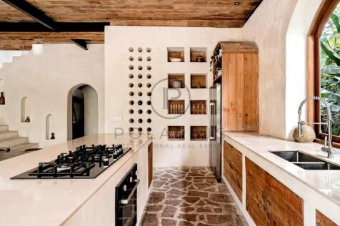A stylish kitchen featuring a sleek gas stove on a