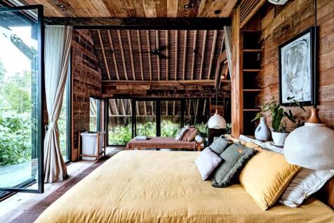 Cozy wooden bedroom with a large bed, decorative p