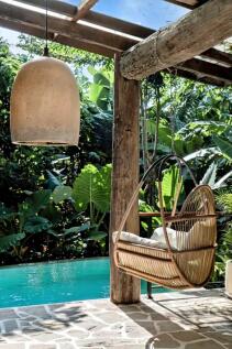 A cozy outdoor setting with a hanging chair and a 
