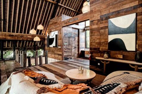 A cozy, rustic interior with wooden walls and ceil