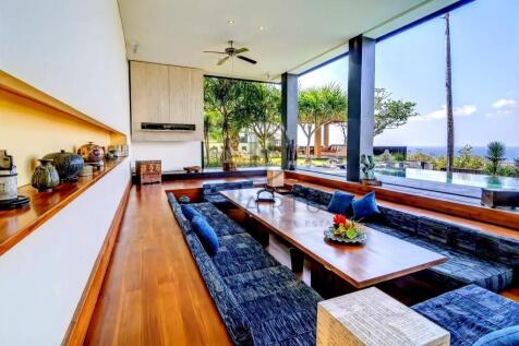 A modern, open-concept living room with a long woo