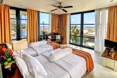 Bright hotel room with two twin beds, colorful bla