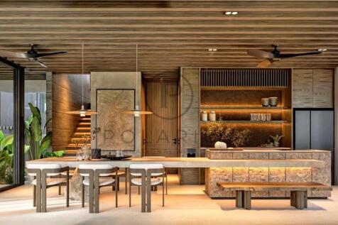 A modern, open-concept dining and kitchen area fea