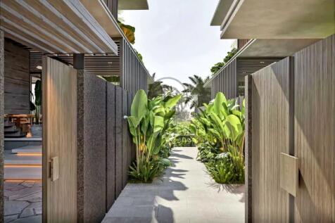 Modern outdoor walkway lined with lush plants and 