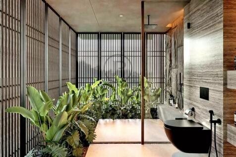 A modern bathroom with large windows, wooden panel