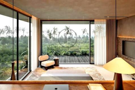 A modern, luxurious room features large glass wind
