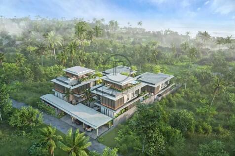 A modern, multi-level house surrounded by lush gre