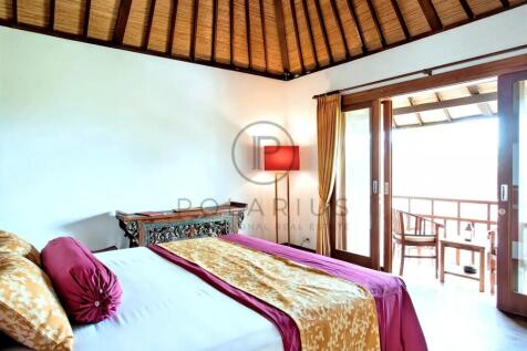 A cozy bedroom with a wooden ceiling features a be